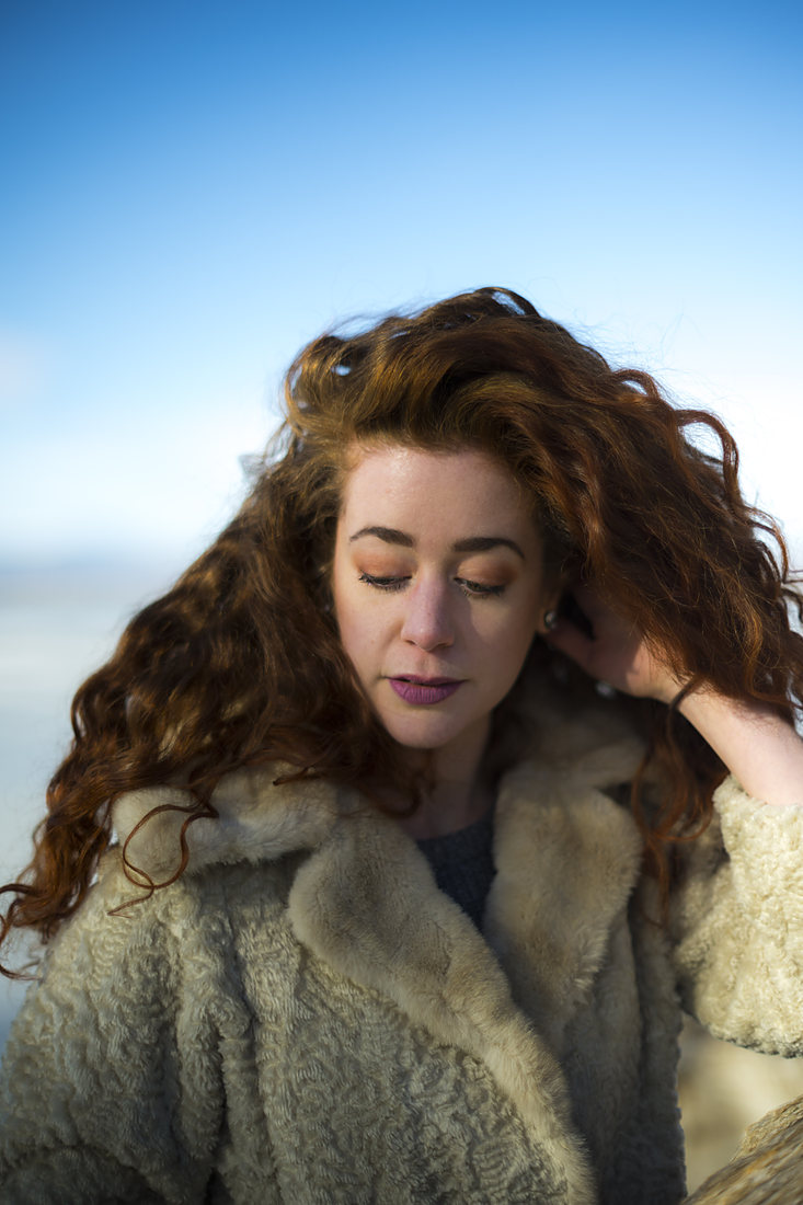 Wind-swept portrait under an open sky